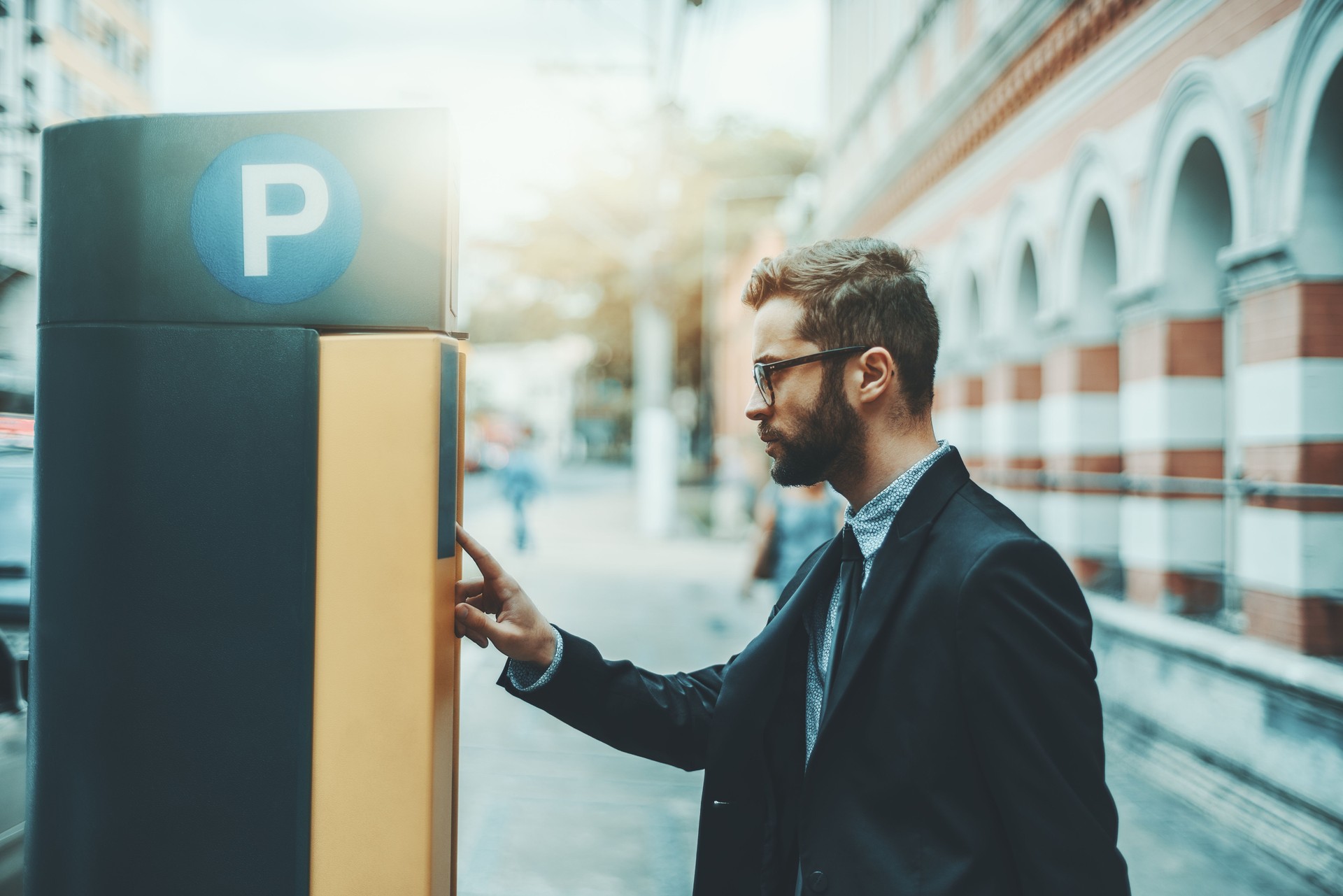 Businessman using Parking Meter outdoors