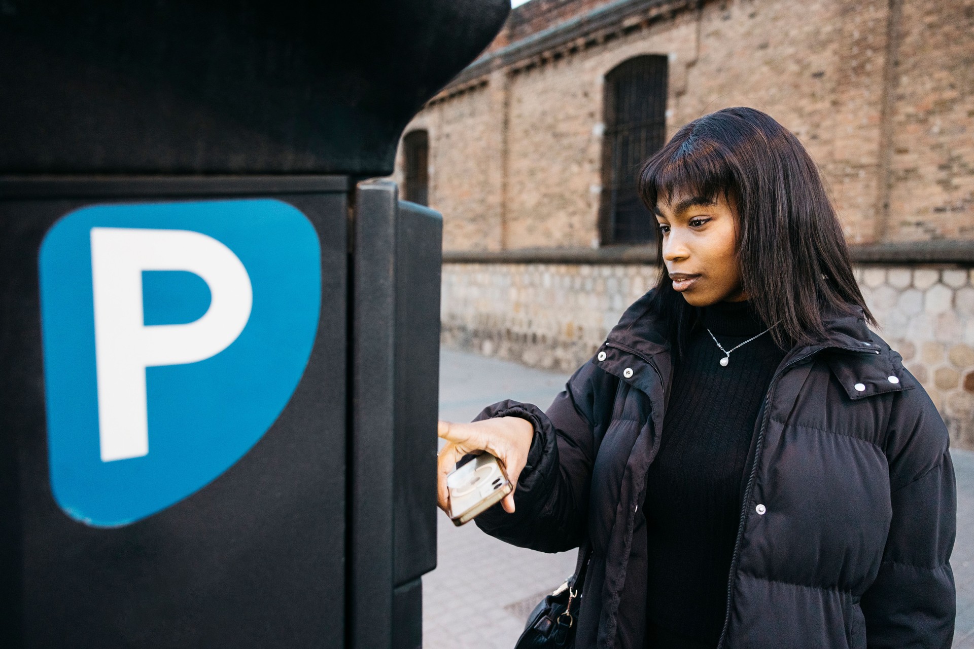 Woman making mobile payment for parking.
